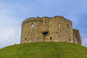 Clifford's Tower, York Castle. In 1068, King William ordered a motte and bailey castle here. Some claim built in 8 days. Ironically, Vikings of Denmark with help from York rebels burned down the motte and bailey castle. The stone fortress came later.